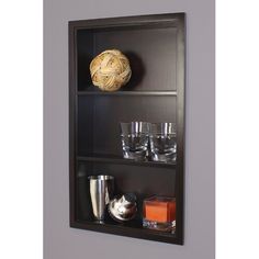 a wall mounted shelf filled with glasses and a ball