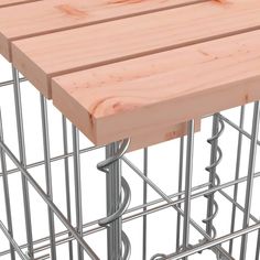 a close up of a wooden table with metal bars on it's sides and a wire frame around the top