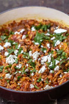 a pot filled with lots of food on top of a table