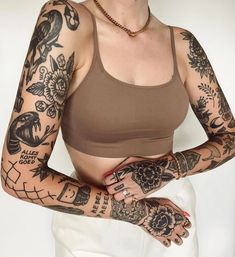 a woman with many tattoos on her arms