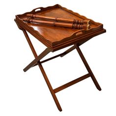 a tray with a knife on it and a wooden handle sitting on top of a folding table