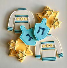 decorated cookies in the shape of hanukkah, star of david and mittens