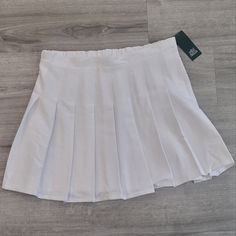 Womans White Pleaded Skirt . Size Large Nwt. Preppy Mini Tennis Skirt, Spring School Uniform Style Tennis Skirt In Solid Color, White High-waist Bottoms For School, Preppy Stretch Pleated Skirt, Stretch Preppy Pleated Skirt, White Skort For School, Preppy Solid Pleated Skirt, Summer School Uniform Style Lined Skirt, Fitted White School Uniform Skirt