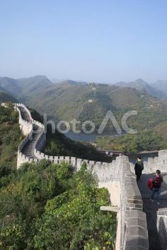 two people walking up the great wall of china