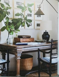 an image of a table and chairs in a room with pictures on the wall behind it