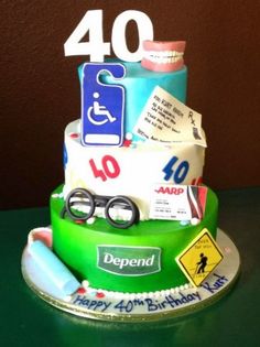 a green birthday cake with the number forty on it's top and various items