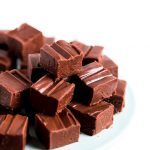 a pile of chocolate pieces sitting on top of a white plate