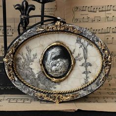 an ornately decorated clock with music sheets in the background