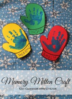 three handprinted mittens are sitting on a table