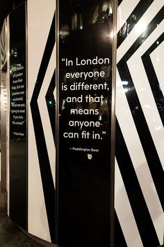 a black and white striped wall with a quote on it's side that says in london everyone is different, and that means anyone can fit in