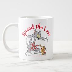 a white coffee mug with the words spread the love on it and an image of a cat