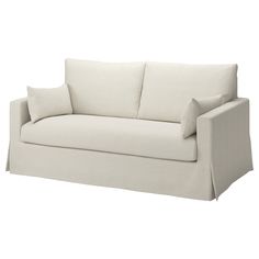 a white couch with two pillows on it