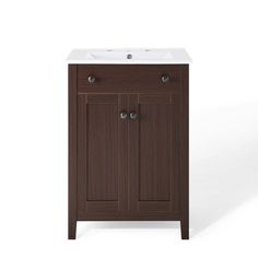 a bathroom vanity with a white sink and dark wood cabinet doors on the front side