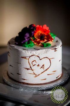 a white cake with flowers on top of it