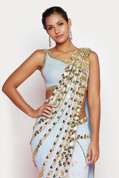 Powder blue pre-stitched saree with golden hearts, beads, floral motif embroidery. Paired with a placement embroidered blouse. - Aza Fashions Blue Fitted Pre-draped Saree, Sleeveless Pre-draped Saree For Summer Festivals, Fitted Tops For Spring Reception, Blue Sleeveless Pre-draped Saree For Festive Occasions, Spring Reception Fitted Blouse, Sleeveless Summer Festive Pre-draped Saree, Summer Festive Sleeveless Pre-draped Saree, Blue Traditional Drape Top For Reception, Blue Tops For Reception With Traditional Drape