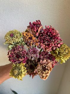 a person holding a bunch of flowers in their hand