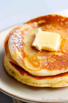 a stack of pancakes with butter on top