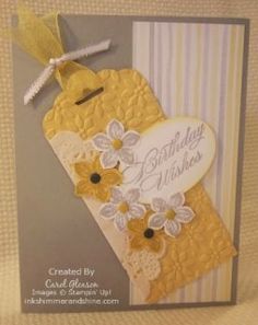 a handmade birthday card with flowers and a tag on the front that says happy birthday wishes