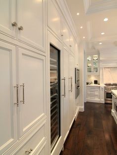 the kitchen is clean and ready for us to use it's white cabinetry