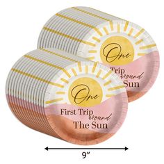 two pink and gold foil plates with the words one trip around the sun on them