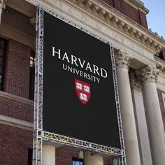 a large sign on the side of a building that says harvard in front of it