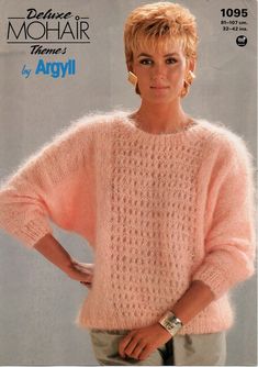 a woman wearing a pink sweater with short hair in front of an advertisement for mohair