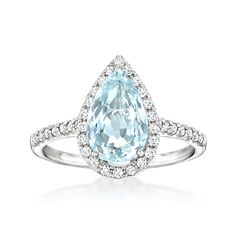 an aqua blue topazte and diamond ring with diamonds around it on a white background