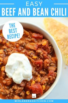 a white bowl filled with beef and bean chili next to a piece of pita bread