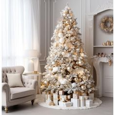 a white christmas tree with gold and silver ornaments in a living room decorated for the holidays