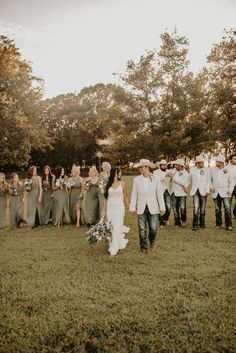 a group of people that are standing in the grass