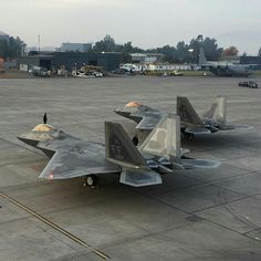 three fighter jets parked on the tarmac at an airport