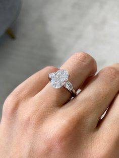 a woman's hand with a diamond ring on it