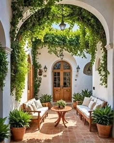 an outdoor patio with potted plants on the wall and wooden furniture in the middle