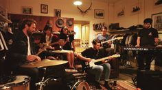 a group of people playing instruments in a room