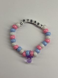 Handmade purple Melanie Martinez Cry Baby beaded bracelet made with love by a teenage self taught art enthusiast! This bracelet was made with plastic pony beads and a plastic pacifier charm. Meline Martinez, Melanie Martinez Cry Baby, Aesthetic Bracelets, Melanie Martinez Merch, Scene Goth, Art Enthusiast, Makeup Spray