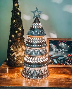 a small christmas tree sitting on top of a wooden table