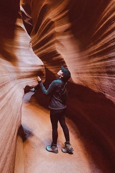 a person standing in the middle of a narrow slot