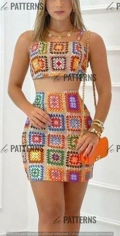 a beautiful young woman posing in a short dress with colorful crochet on it