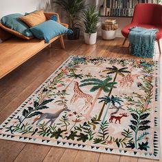 a living room filled with furniture and a rug on top of a hard wood floor