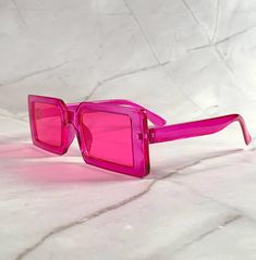 Vintage 90s rectangle steampunk sunglasses, pink square shape frame and lightweight. Always an excellent choice for summer vacation, beach party or any other occasion, very good quality. New old stock. Great condition. Never worn. UV Protection. NOS Deadstock Free combined shipping worldwide. FIT INFORMATION 50 mm Eye Size 18 mm Bridge 150 mm Temple/Arm Width 5 1/2 Inches Height 1 3/4 Inches Retro Rectangle Sunglasses, Pink Square Frame Sunglasses For Beach, Pink Retro Sunglasses, Retro Pink Square Frame Sunglasses, Luxury Pink Square Frame Sunglasses, Steampunk Sunglasses, Pink Frames, Retro Sunglasses, Beach Party