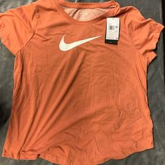 Nike Women’s Plus Size Tshirt Orange New With Tags 1x Nike Summer Workout T-shirt, Graphic Tee T-shirt For Spring Workout, Spring Graphic Tee Tops For Workout, Spring Nike Workout T-shirt, Nike Workout T-shirt For Spring, Nike Basic Moisture-wicking Tops, Nike Basic Relaxed Fit Tops, Nike Basic Tops With Relaxed Fit, Nike Basic Summer Tops