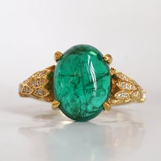 Read about our payment plans before proceeding.This is what dreams are made of. This emerald ring features an insanely gorgeous deep green natural cabochon emerald stone, embellished with 57 natural white diamonds with details like phoenix wings. A classy and sleek ring to treasure forever. Handcrafted in your choice of 14K yellow gold, rose gold, and white gold. The emerald shown is the exact same emerald you will receive. 14K solid gold Natural 12*9mm natural cabochon emerald. Approx. 2.8ct~. Luxury Oval Emerald Birthstone Ring, Yellow Gold Emerald Ring Oval Cabochon, Yellow Gold Emerald Ring With Oval Cabochon, Fine Jewelry Emerald Oval Cabochon Ring, Fine Jewelry Emerald Ring With Oval Cabochon, Emerald Oval Cabochon Ring As A Gift, Exquisite Green Oval Emerald Ring, Exquisite Oval Green Emerald Ring, Green Oval Cabochon Emerald Ring