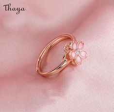 Capture the essence of cherry blossom season with our Silver Sakura Spinner Ring. This elegant piece tells a story of beauty and renewal, as delicate petals bloom and dance in the breeze. The spinner design allows for a soothing sensation, perfect for those seeking balance and serenity in their daily lives. Elevate your style with this stunning symbol of hope and new beginnings.   - Brand: Thaya  - Material: S925 Silver  - Weight : About 2.34g  - Size: Stack Mouth 14th  - Style: Flower  - Gender: Women Delicate Adjustable Rings For Spring, Delicate Spring Flower Ring, Delicate Pink Flower Ring For Wedding, Spring Promise Ring With Open Design, Spring Promise Ring With Open Ring Shape, Spring Open Ring For Promise, Flower Shaped Anniversary Rings For Spring, Dainty Spring Wedding Rings, Spring Gift Open Ring