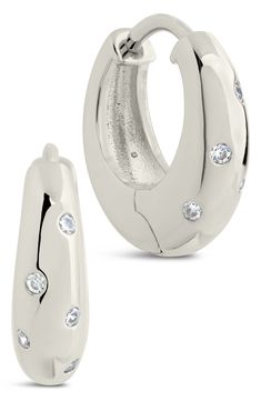 Brightly polished hoops are highlighted further by round-cut cubic zirconia that lend a dose of shine to any ensemble. 0.6" hoop diameter; 0.2" width Hinge with snap-post closure Rhodium plate/cubic zirconia
 Imported Silver Diamond Huggie Earrings Tarnish Resistant, Silver Diamond Tarnish-resistant Huggie Earrings, Modern Small Hoop Cubic Zirconia Earrings, Modern Cubic Zirconia Small Hoop Earrings, Modern Cubic Zirconia Hoop Earrings For Everyday, Modern Everyday Cubic Zirconia Hoop Earrings, Modern Round Cubic Zirconia Huggie Earrings, Modern Cubic Zirconia Huggie Hoop Earrings, Modern Round Cubic Zirconia Hoop Earrings