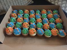 a box filled with cupcakes covered in frosting