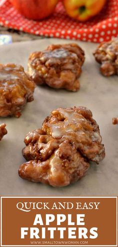 apple fritters on a baking sheet with apples in the background