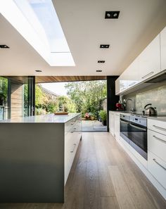 an open kitchen with skylights and white cabinets