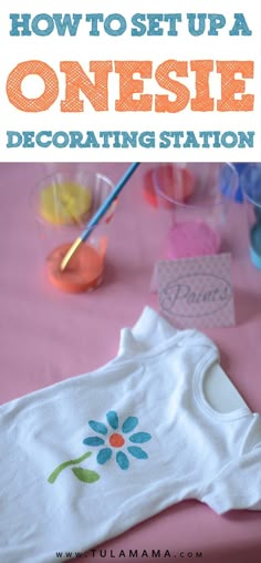 how to set up a onesie decorating station on a pink tablecloth with flowers