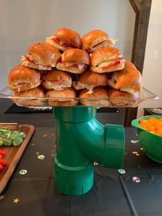 there are many sandwiches stacked on top of each other in the middle of a table