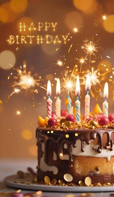 a birthday cake with lit candles and sparklers